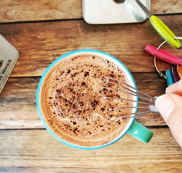 stirring the cocoa with a whisk